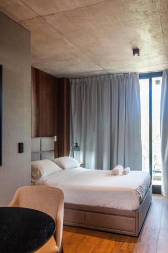 a bedroom with two beds and a window at Live Soho Boutique Apartments Palermo Soho in Buenos Aires
