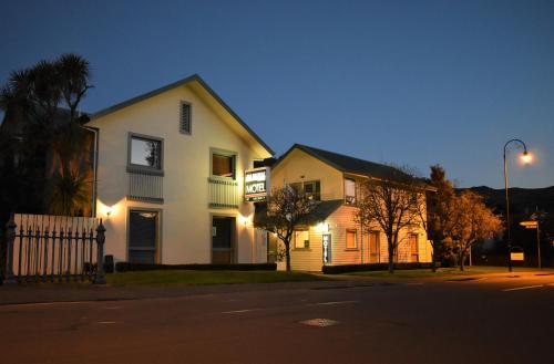 a white house on a street at night at La Rochelle Motel in Akaroa