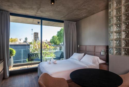 a bedroom with a large bed and a large window at Live Soho Boutique & Apartments Palermo Soho in Buenos Aires