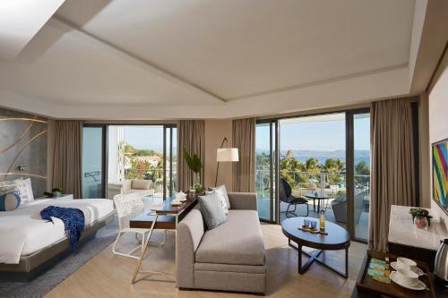 a bedroom with a bed and a living room at The Lind Boracay in Boracay