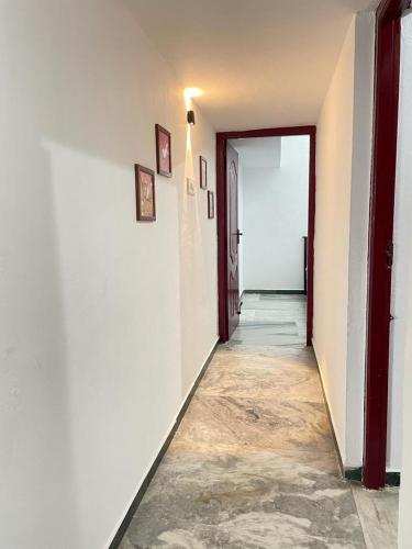 an empty hallway with a door leading to a room at WHITE HOUSE - 3BHK Elite Apartment in Coimbatore