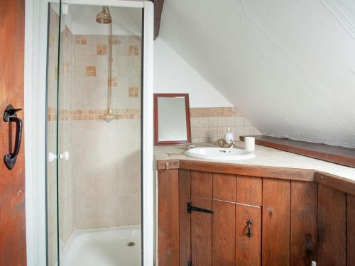 a bathroom with a sink and a shower and a tub at The Barn in Kentisbeare