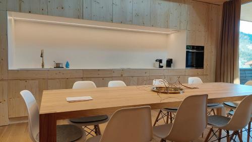 a conference room with a wooden table and chairs at Kranzmuehle - Ankommen am Achensee in Achenkirch