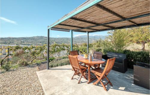 a wooden table and chairs under a pergola at Casa Fiorita in Caramagna Ligure