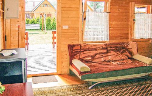 a bedroom with a bed in a wooden house at Awesome Home In Jaroslawiec With Wifi in Jarosławiec