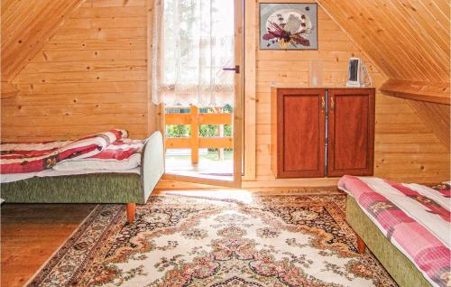 a living room with a bed and a sliding glass door at Beautiful Home In Jaroslawiec With Wifi in Jarosławiec