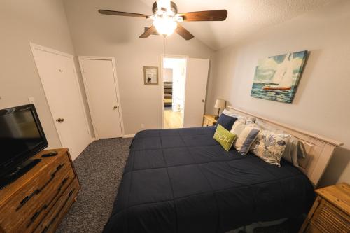 a bedroom with a bed and a flat screen tv at Beach Mode ON! in Galveston