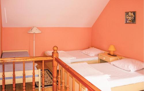 Amazing Home In Rewal With 1 Bedrooms في ريفال: سريرين في غرفة بجدران برتقالية