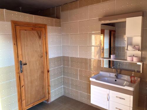 a bathroom with a sink and a mirror at Wadi Rum in Wadi Rum