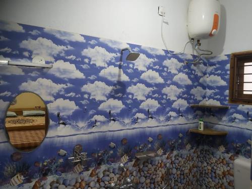 a mural of clouds on a wall in a room at Suloram illam in Chidambaram