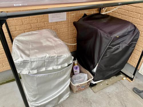 a pile of trash under a table with a trash bag at Hotel EL Shinjuku 6 in Tokyo