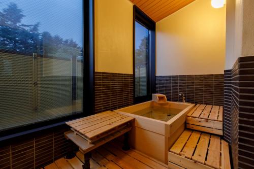a bathroom with a sink and a large window at Matsusaki in Nomi
