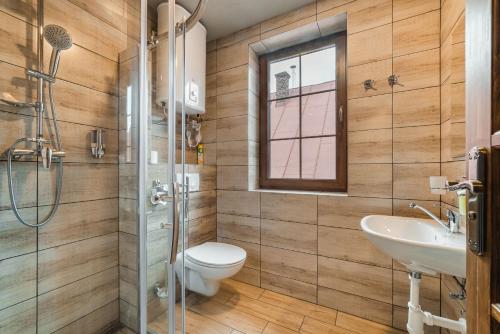 a bathroom with a toilet and a sink and a shower at Privat LeNa in Ružomberok