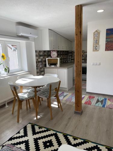 a kitchen with a table and chairs in a room at Apartman Maki in Sarajevo