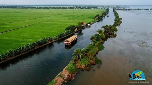 an aerial view of a river with a truck at Vaishnav Tours in Alleppey