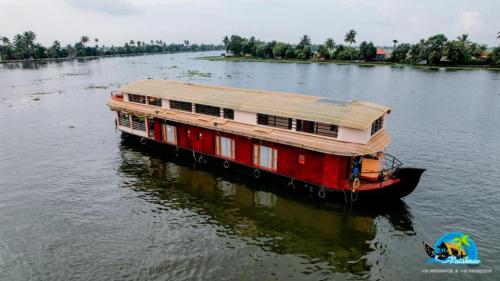 a boat with a roof on a river at Vaishnav Tours in Alleppey