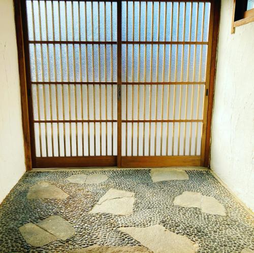 an open door to a room with a mosaic floor at 洲本家　SUMOTOYA in Sumoto