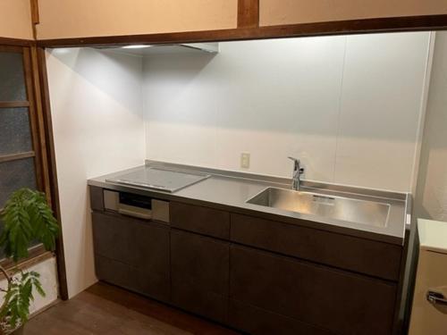 a kitchen with a sink and a counter top at 洲本家　SUMOTOYA in Sumoto