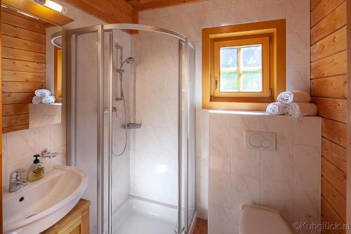 a bathroom with a shower and a sink at Kuhglück Koralpe in Elsenbrunn