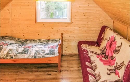 a room with two beds and a window at 2 Bedroom Pet Friendly Home In Karwienskie Blota in Karwieńskie Błoto Pierwsze