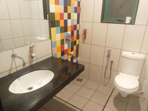 a bathroom with a sink and a toilet at Hotel Casa De Patio in Porvorim
