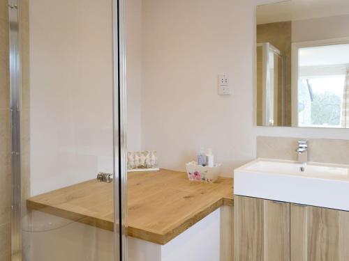 a bathroom with a sink and a counter with a mirror at Wyedale in Bakewell
