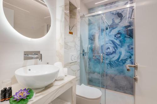 a bathroom with a sink and a shower at Flos Luxury Rooms in Split