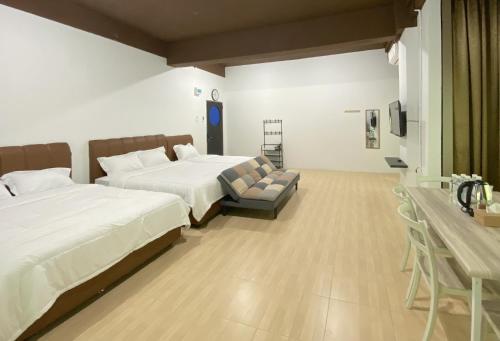 a hotel room with two beds and a couch at CN Homestay C3 Floor 3 at Nagoya Hill Mall in Nagoya