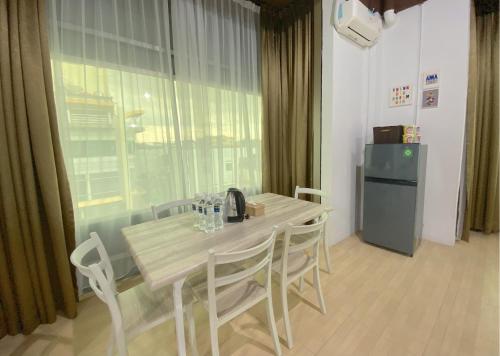 a table and chairs in a room with a window at CN Homestay C3 Floor 3 at Nagoya Hill Mall in Nagoya