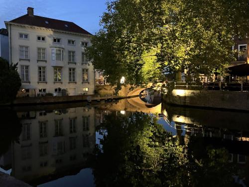 a view of a canal in a city at night at B&B My Suite Home in Bruges