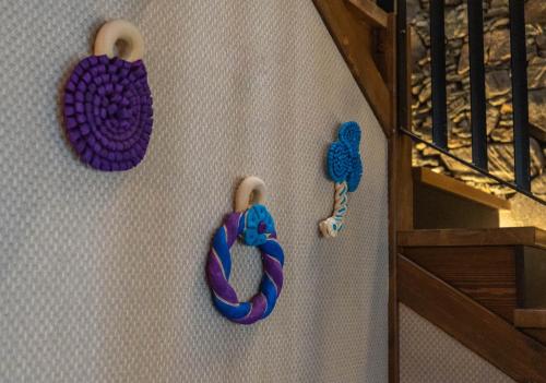 a wall with two crocheted donuts on a wall at Casa Rural San Andrés de Teixido in Cedeira