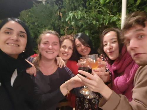 a group of people posing for a picture holding wine glasses at Tuta House Sighnaghi in Sighnaghi