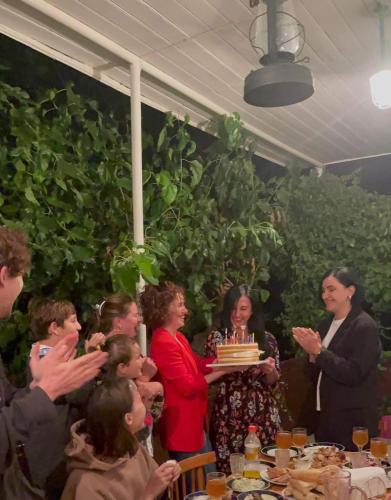 a group of people sitting at a table with a cake at Tuta House Sighnaghi in Sighnaghi