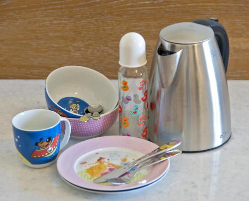 a counter with a coffee pot and plates and cups at Kydon The Heart City Hotel in Chania Town