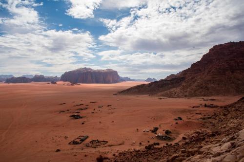 a view of the desert with mountains and rocks at Wadi Rum in Wadi Rum