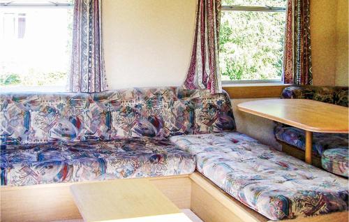 a couch in a room with a table and a window at Gorgeous Stacaravan In Darlowo in Darłowo