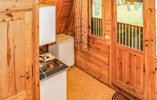 an interior view of a kitchen in a log cabin at Gorgeous Apartment In Lukecin With Kitchen in Łukęcin