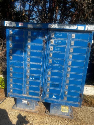 a blue metal box sitting on the side of a sidewalk at Thedreamlifehouse in Anavissos