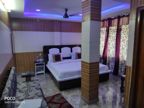 a bedroom with a bed in a room at Hotel Diamond, Meerut in Meerut