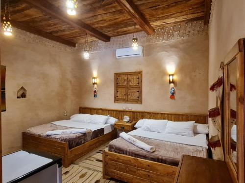 a bedroom with two beds in a room at Qasr El salam in Siwa