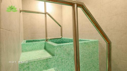La Grande Residence- Grand Studio في انجلس: دش مع حوض استحمام ذو بلاط أخضر في الحمام