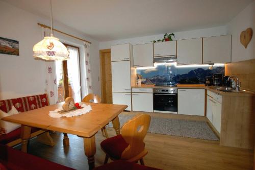 a kitchen with a wooden table and a dining room at Haus Tasser in Mayrhofen