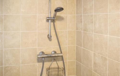 a shower with a shower head and a basket at Gorgeous Home In Vallavik With House Sea View in Kaland