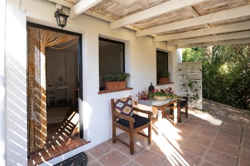 a patio with a table and chairs on a porch at A natural retreat in Mijas