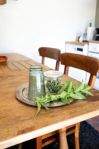 a wooden table with a plate with a jar on it at A natural retreat in Mijas