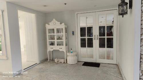 a room with a white cabinet and a cat in it at Boathouse Hua Hin Seaview in Ban Bo Fai