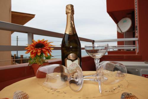 a bottle of champagne and glasses on a table at GB Case Vacanze Sicilia in Balestrate