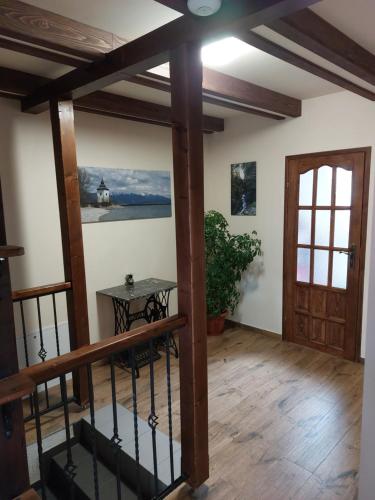 a room with a staircase and a table and a door at Privat LeNa in Ružomberok