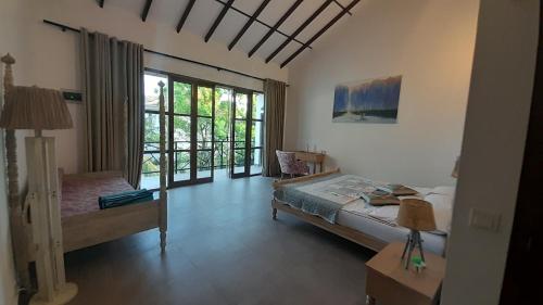 a bedroom with a bed and a window with a view at villa Mosaic in Tangalle