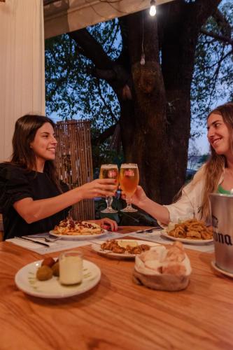 two women sitting at a table with glasses of wine at Casa Lola in Yerba Buena